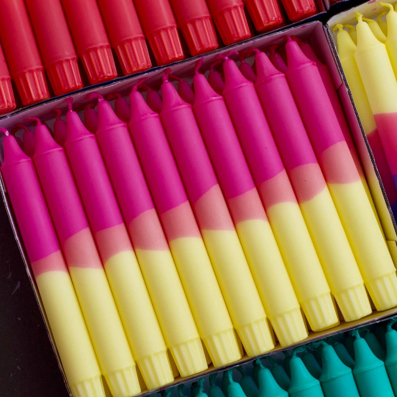 set of colourful searin wax candles in pink and yellow